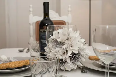 a table with a bottle of wine and two glasses at Sweet Arco Farnese in Rome