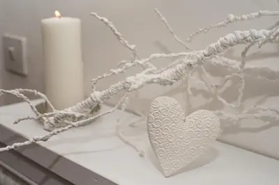 a white heart on a table with a candle at Sweet Arco Farnese in Rome