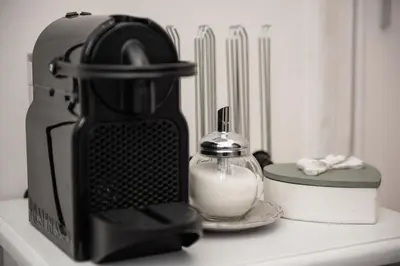 a black blender and a container of milk on a counter at Sweet Arco Farnese in Rome
