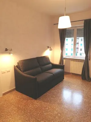 a black couch in a living room with a window at B&B Pigneto7 in Rome