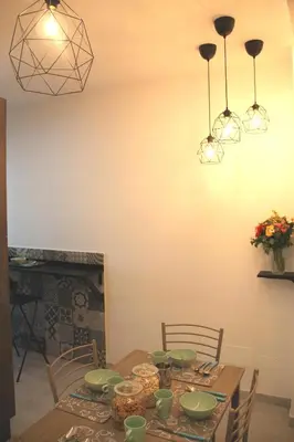 a dining room table with green dishes on it at B&B Pigneto7 in Rome
