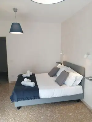 a bedroom with a bed with white sheets and pillows at B&B Pigneto7 in Rome
