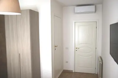 a hallway with a white door and a white closet at B&B Pigneto7 in Rome