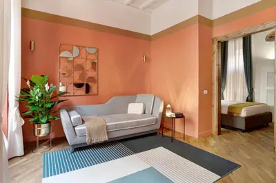 a living room with a couch and a bed at Luxury Trevi House in Rome