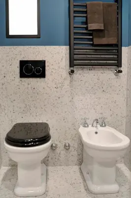 a bathroom with a toilet and a sink at Luxury Trevi House in Rome