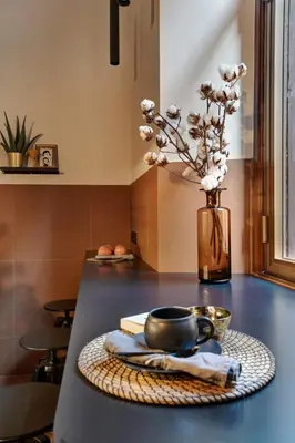 a table with a bowl and a vase with flowers at Luxury Trevi House in Rome
