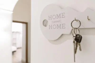 a pair of keys hanging on a home sweet home sign at Vatican Apartment Santamaura in Rome