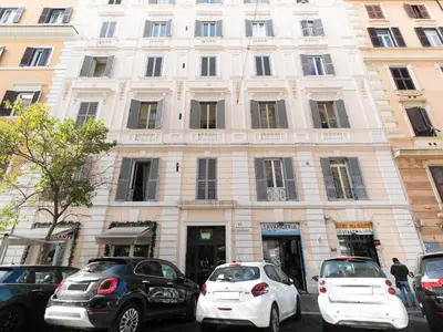two white cars parked in front of a building at Vatican Apartment Santamaura in Rome