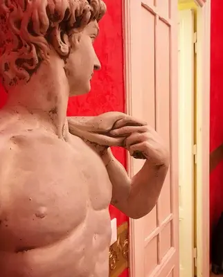 a statue of aalkyrie standing in front of a mirror at La Breccia A Porta Pia in Rome