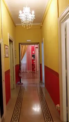 an empty hallway with a chandelier in a building at La Breccia A Porta Pia in Rome