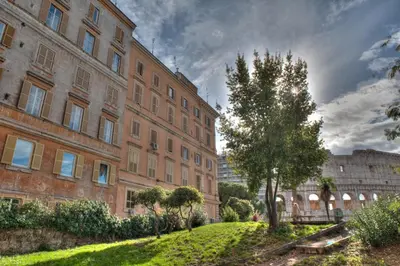 a large brick building with a tree in front of it at ROMANCE AL COLOSSEO 2 in Rome