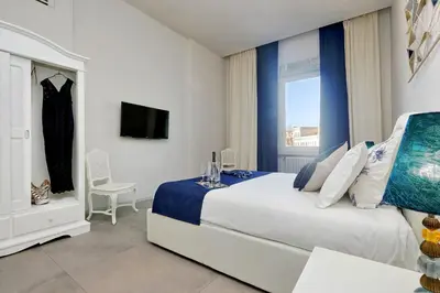 a bedroom with a large bed and a window at ROMANCE AL COLOSSEO 2 in Rome