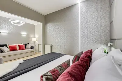 a bedroom with a large white bed with red pillows at Charming Studio - Spanish Steps in Rome