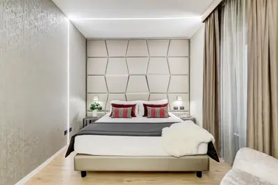 a bedroom with a large bed with red pillows at Charming Studio - Spanish Steps in Rome
