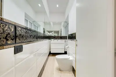 a white bathroom with a toilet and a sink at Charming Studio - Spanish Steps in Rome