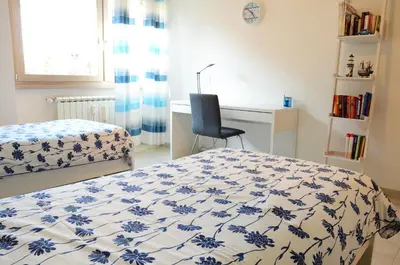a bedroom with a bed and a desk and a chair at La casa di Egle in Rome