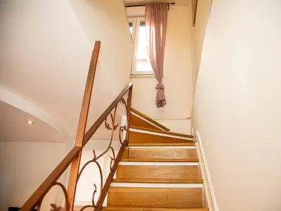 a winding staircase in a house with a window at San Pietro apart in Rome