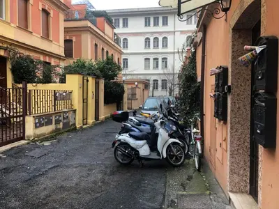 a row of motorcycles parked on a street at San Pietro apart in Rome