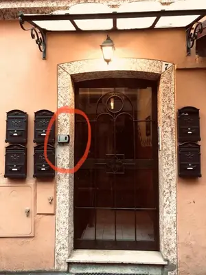 a door to a building with a light on it at San Pietro apart in Rome