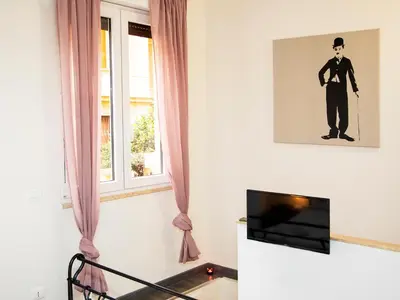 a living room with a tv and a window at San Pietro apart in Rome