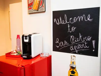 a sign that says welcome to your living room with a coffee machine at San Pietro apart in Rome