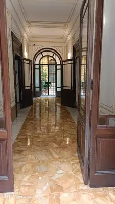 an empty hallway of a building with doors and floors at House 4 Mori in Rome