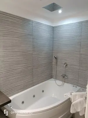 a bathroom with a bath tub with a shower at House 4 Mori in Rome