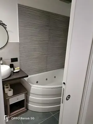 a bathroom with a tub and a toilet and a sink at House 4 Mori in Rome