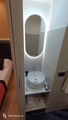 a bathroom with a sink and a mirror at House 4 Mori in Rome