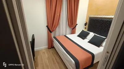 a bedroom with a bed with orange curtains at House 4 Mori in Rome