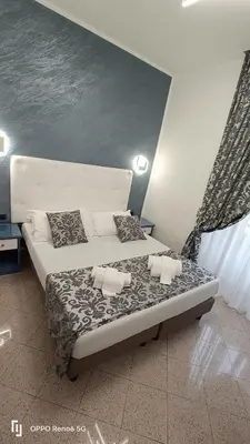 a bed with two pillows on it in a room at House 4 Mori in Rome