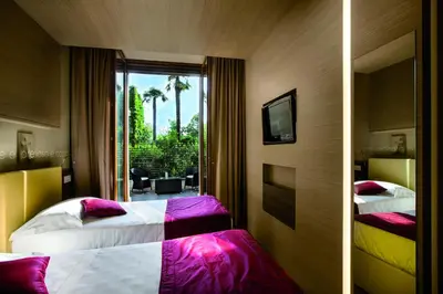a hotel room with two beds and a window at Hotel Il Cantico St. Peter in Rome