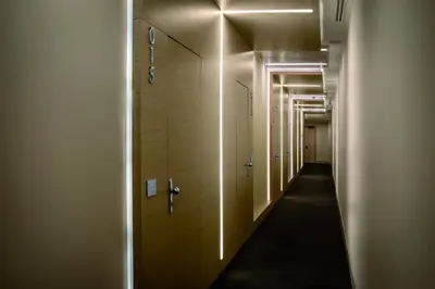 a row of stalls in a hallway with lights at Hotel Il Cantico St. Peter in Rome