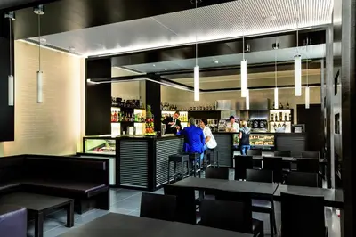 a restaurant with people standing at the bar at Hotel Il Cantico St. Peter in Rome