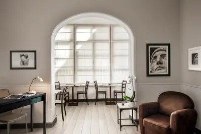 a living room with a table and chairs and an archway at Nazionale 51 Group in Rome