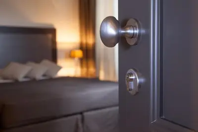 a doorhandle to a door with a bed in a room at Nazionale 51 Group in Rome