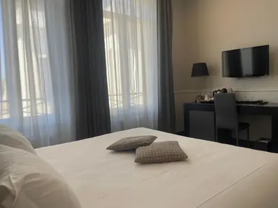 a bedroom with a bed with two pillows on it at Nazionale 51 Group in Rome