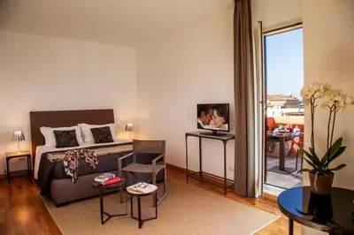 a bedroom with a bed and a living room at Nazionale 51 Group in Rome