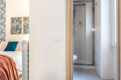 a bedroom with a bed and a bathroom at Appartamento Flora Metro Vittorio in Rome