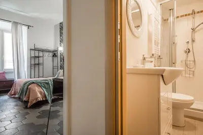 a bathroom with a sink and a bed at Appartamento Flora Metro Vittorio in Rome