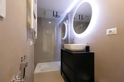 a bathroom with a sink and a mirror and a tub at LC GrandTour Libertà in Rome