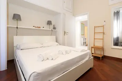 a bedroom with a white bed with towels on it at LC GrandTour Libertà in Rome