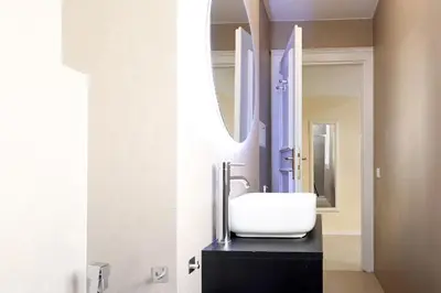 a bathroom with a sink and a mirror at LC GrandTour Libertà in Rome