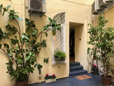 a house with a staircase and a window and plants at Lata Rana Colosseum Luxury Loft in Rome