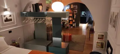 a living room with a lamp on a glass wall at Lata Rana Colosseum Luxury Loft in Rome