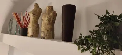 three wooden vases sitting on a shelf next to a plant at Lata Rana Colosseum Luxury Loft in Rome