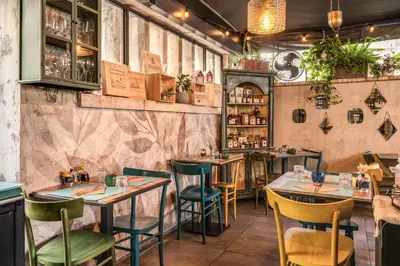 a restaurant with tables and chairs and a bar at Apollo Boutique Hotel in Rome