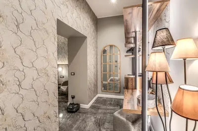 a lobby with a stone wall and two lamps at Apollo Boutique Hotel in Rome