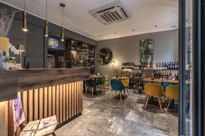 a bar in a restaurant with tables and chairs at Apollo Boutique Hotel in Rome