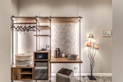 a room with a desk and a shelf and a table at Apollo Boutique Hotel in Rome